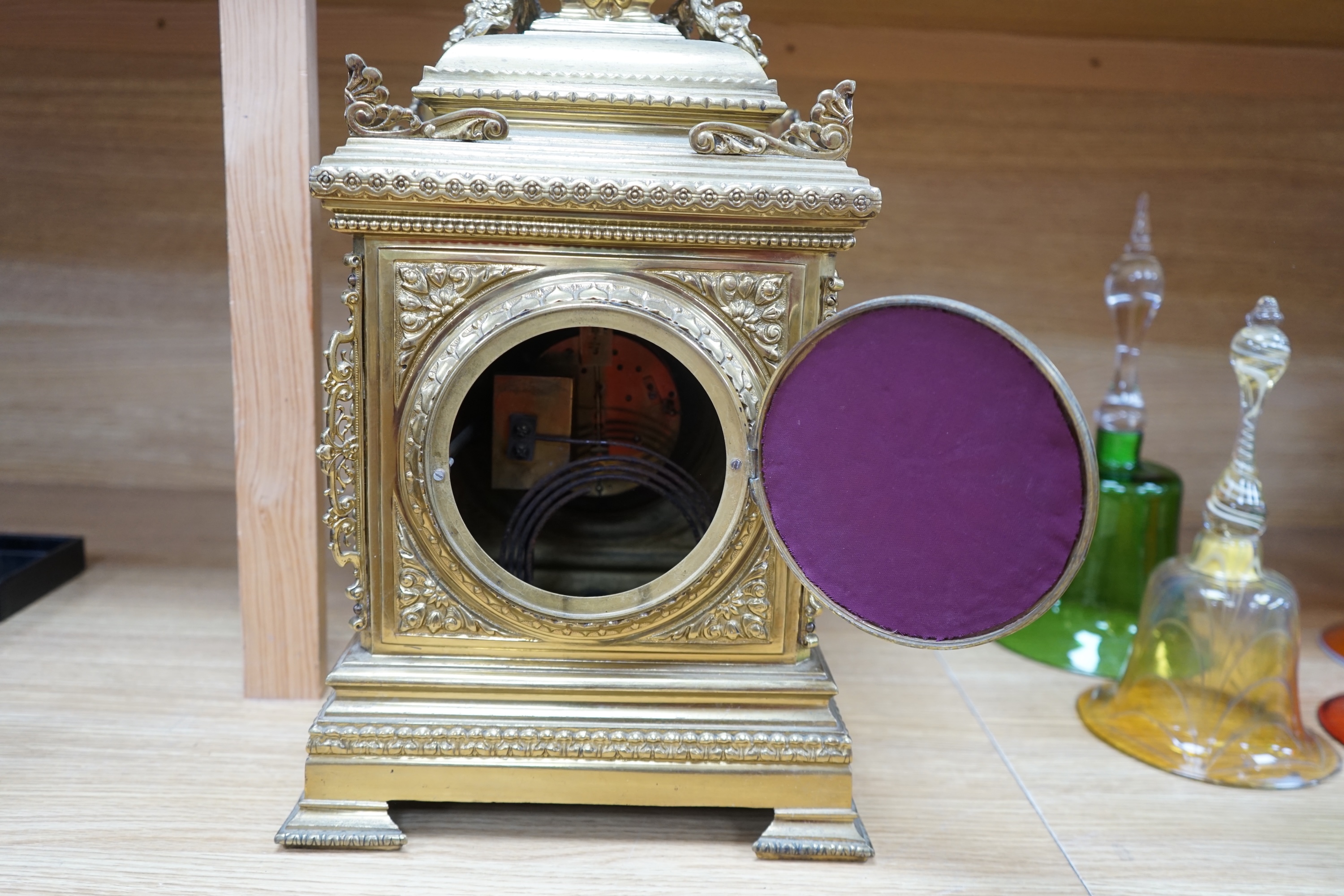 A Louis XVI style ormolu mantel clock with enamel dial, key and pendulum, 42cm. Condition - fair to good